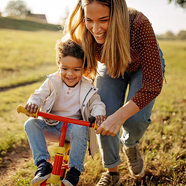Mother learning her son to drive bike